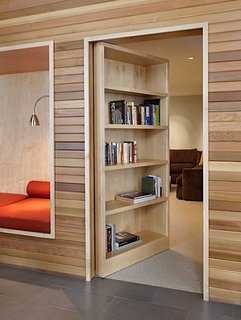 10 Homes With Clever Storage Solutions - Photo 7 of 10 - The empty nesters who own this house on Lake Wenatchee in Washington wanted a home that could accommodate their college-aged kids and their friends when they visit. Architect John Deforest created a secret media room hidden behind a door with a bookshelf in the front, giving the couple a place to keep their books, as well as their visiting children and guests.