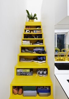 10 Homes With Clever Storage Solutions - Photo 9 of 10 - Architect Andrew Maynard’s Melbourne home, which also doubles up as the office of his practice Austin Maynard Architects, includes a bright yellow staircase with opening slots in the front that serve as storage shelves.
