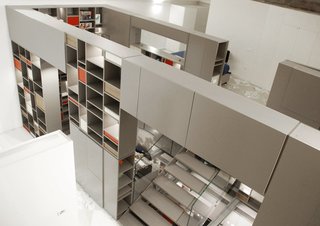 10 Homes With Clever Storage Solutions - Photo 10 of 10 - For this family loft in Florence, Italy, architecture practice Fabbricanove created an almost sci-fi-like, 26-foot-tall storage structure with drawers and shelves that organize everything associated with the various aspects of living in the loft.