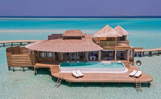 9 Modern Maldivian Resorts With Spectacular Overwater Villas - Photo 2 of 9 - This resort is surrounded by 3.5 miles of private lagoons and includes villas with retractable roofs, private pools with catamaran nets, and even waterslides.