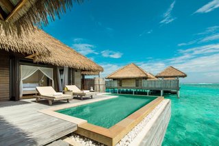 9 Modern Maldivian Resorts With Spectacular Overwater Villas - Photo 3 of 9 - The 1,152-square-foot overwater villas at this resort have wide doors that open to a terrace with a plunge pool facing the turquoise lagoon, as well as their own private jetties.