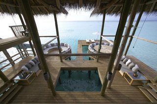 9 Modern Maldivian Resorts With Spectacular Overwater Villas - Photo 6 of 9 - This resort has 45 overwater villas, including the Crusoe Residences with its own rooftop sundeck and private water hammock. The 5,577-square-foot Private Reserve has a sundeck with an infinity pool, spa, sauna, steam room, gym, and a bathtub built over coral gardens.