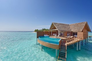 9 Modern Maldivian Resorts With Spectacular Overwater Villas - Photo 9 of 9 - The thatched-roof Water Pool villas at Milaidhoo Island are equipped with Maldivian-style swing chairs, ocean-facing king sized beds, and large private pools.