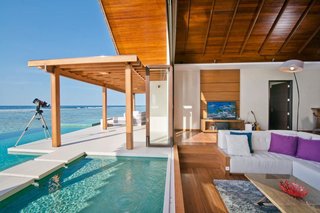 9 Modern Maldivian Resorts With Spectacular Overwater Villas - Photo 1 of 9 - Sleek and commodious, some of the villas in this resort have indoor and outdoor showers as well a jacuzzi that’s great for a leisurely soak under the stars at night.