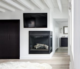 SU11 Architecture+Design designed this Grand Street loft in New York with a sleek, minimalist corner fireplace built with perpendicular glass panels.