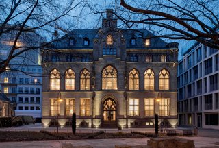 12 Modern Hotels in Historic Buildings Around the World - Photo 17 of 24 - Vaulted ceilings, high window arches, and stone staircases are retained in the guest rooms and public spaces of this gothic-style city archive building, which is now a a stylish hotel that's furnished with 20th-century furniture designed by Walter Gropius, Charles and Ray Eames, and Ludwig Mies van der Rohe.
