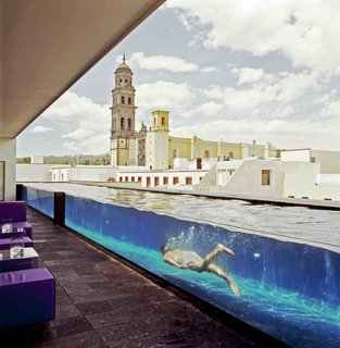 12 Modern Hotels in Historic Buildings Around the World - Photo 23 of 24 - This boutique hotel sits in a former 19th-century water purification faction. Its sleek glass panels and modern furnishings exist in symbiosis with the old factory walls, stone columns, and aqueducts.
