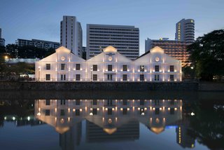 12 Modern Hotels in Historic Buildings Around the World - Photo 21 of 24 - This dockside warehouse from 1895 was converted into a hotel with voluminous rooms, high ceilings, concrete walls, and exposed beams that are complemented by elegant furniture with sleek metallic details.