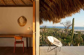 7 Modern Hotels in Mexico You Have to Visit - Photo 3 of 7 - Architect Federico Rivera Rio updated traditional beach huts in Oaxaca with palapa roofs, transforming them into stylish, minimalist bungalow hotel rooms with stucco walls, wooden floors, and polished concrete bathrooms.