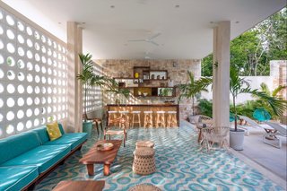 7 Modern Hotels in Mexico You Have to Visit - Photo 2 of 7 - Inspired by midcentury architecture in Miami, this hotel located within a yoga retreat community center known as Holistika Tulum is a retro jungle oasis with cool custom-made floor tiles, rattan chairs, and a calming aquamarine color scheme.