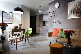 10 Small Apartments by a Hong Kong Design Studio That Are Less Than 1,000 Square Feet - Photo 1 of 10 - Budget was something that JAAK had to keep in mind when working on their first residential project in 2013. They incorporated full-height storage features close to the entrance and combined the dining and living areas. 