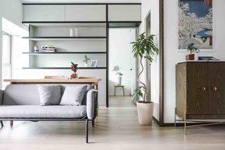 10 Small Apartments by a Hong Kong Design Studio That Are Less Than 1,000 Square Feet - Photo 10 of 10 - Cindy’s home includes a shelf inspired by fretwork, which is often found in traditional Chinese wooden and bamboo furniture. JAAK combined the study area with the dining room using a single large table that can be transitioned from a dining table to a desk. 