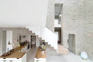 10 Modern Structures That Use Brick in Interesting Ways - Photo 5 of 10 - In a historic renovation of a home from 1844 in the neighborhood of Prenzlauer Berg in Berlin, the original brick walls of the house were left exposed to pay homage to the property’s rustic legacy as the home of a town miller.