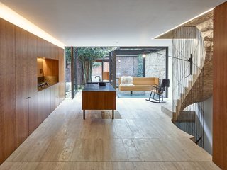 10 Modern Structures That Use Brick in Interesting Ways - Photo 6 of 10 - In this Edwardian house in London, the colors and textures of the brick walls that form the perimeter of the outdoor courtyard can be seen through floor-to-ceiling windows in the kitchen.