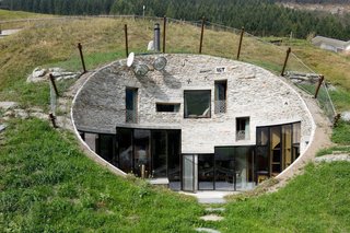 8 Subterranean Homes That Are Out of This World - Photo 1 of 8 - Looking like a burrow on the side of a mountain, Villa Vals—a Swiss vacation rental available through Boutique Homes—was designed by Architects Bjarne Mastenbroek of SeARCH and Christian Müller of CMA. The entrance to the property is through a nearby wooden barn, which has a concealed underground tunnel that runs through the mountain into the villa’s subterranean core.