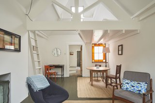 6 Best Dwell UK Apartments - Photo 7 of 7 - The quaint living space features a stained-glass window, a lofted sleeping platform, vaulted ceilings, and arched-sash windows. 