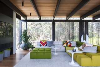 11 Amazing Australian Homes - Photo 2 of 11 - This house in the Mornington Peninsula in the south of Melbourne is filled with materials like natural stone, steel, and cedar, which serve as perfect backdrops for the bold colors and edgy midcentury furniture that firm SJB employed in the space.