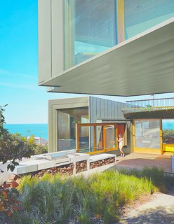 11 Amazing Australian Homes - Photo 7 of 11 - Sited along the Great Ocean Road, this contemporary home in the village of Fairhaven was designed by architect John Wardle. Surrounded by Eucalyptus trees and facing the sea, the house’s kitchen leads to an outdoor deck and BBQ area that’s perfect for post-surf dinners.