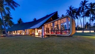 7 Incredible Island Villas in Indonesia - Photo 4 of 7 - Designed by Canadian architect David Lombardi and set along an almost deserted beach in Lombok, this five-bedroom modern architectural gem has a torch-lined timber pathway and a guesthouse built into a manmade, grass-covered hill. 