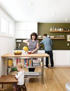 4 Decluttering Tips From Organizing Master Marie Kondo - Photo 3 of 4 - Custom floating shelves and a bookshelf under a movable island counter creates a fuss-free, streamlined look in this kitchen.