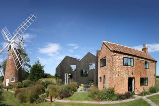 9 Traditional-Turned-Modern Cottages You Can Rent in the UK - Photo 4 of 9 - Designed by ACME, this sensitively restored mill keeper’s cottage on the bank of Norfolk’s River Ant has a new addition made from solid laminated wood that acts as a shadow of the original cottage.