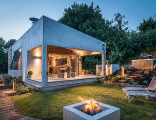 9 Traditional-Turned-Modern Cottages You Can Rent in the UK - Photo 8 of 9 - Formerly an annex that was part of an existing heritage thatch cottage, The Hide was fully revamped with concrete and silver-wood shingles, a series of small, square-like, peephole windows, and two large and angled overhanging windows to create a stunning modern retreat.