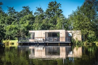 7 Modern Modular and Prefabricated Homes in the UK - Photo 3 of 7 - In 14 weeks, UK prefab and modular home builders Boutique Modern completed this off-the-grid lakeside home that sits deep in Dorset’s Hook Park Forest. The house draws water from the lake and electricity is produced via solar panels and stored in a battery. Extra energy can be generated with a small diesel generator when needed.
