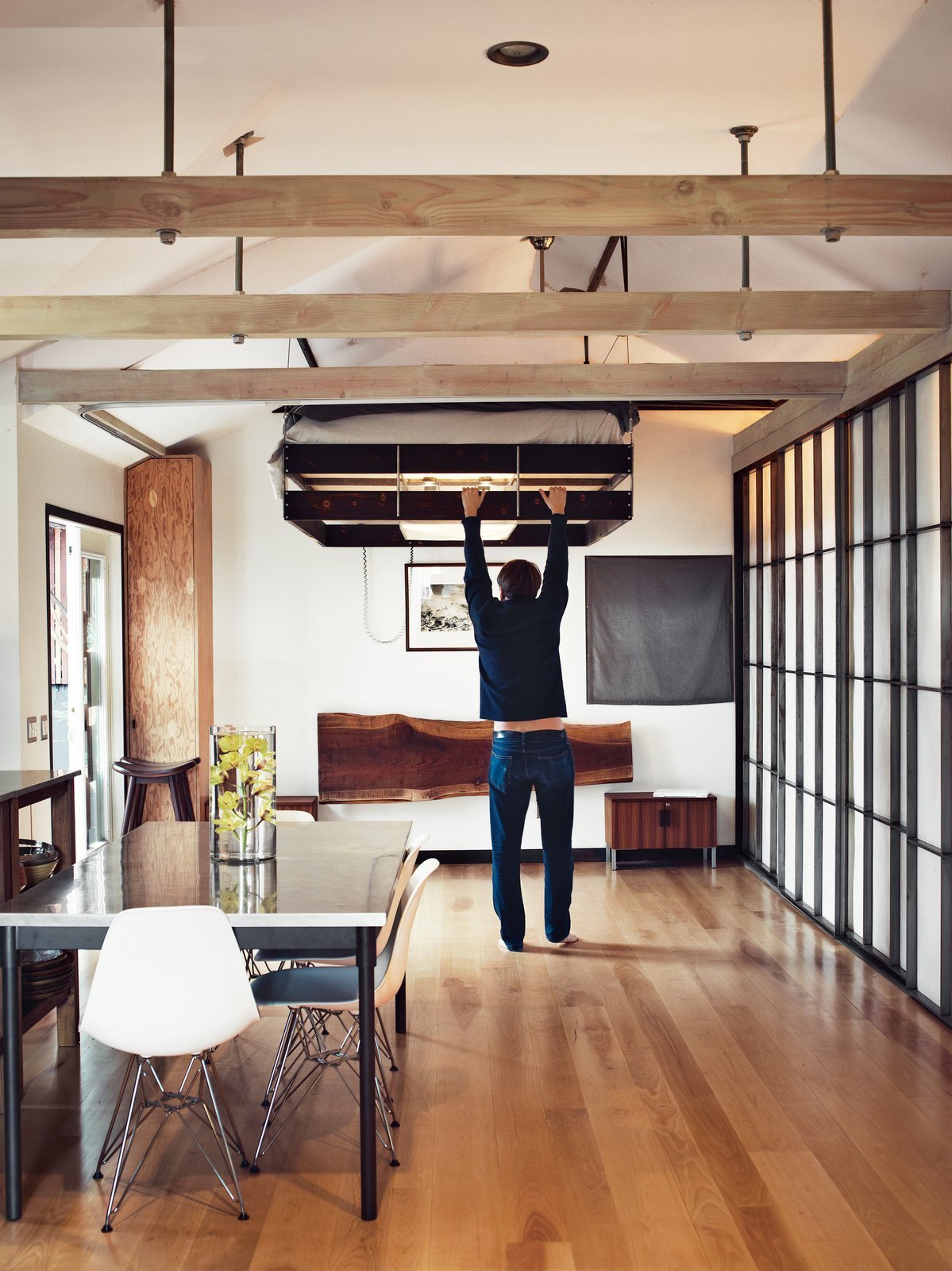 When redesigning “Madmen” actor Vincent Kartheiser’s Hollywood cabin, architect Funn Roberts installed custom shoji-style screens of to conceal the closet and provide privacy for the adjacent shower and soaking tub.