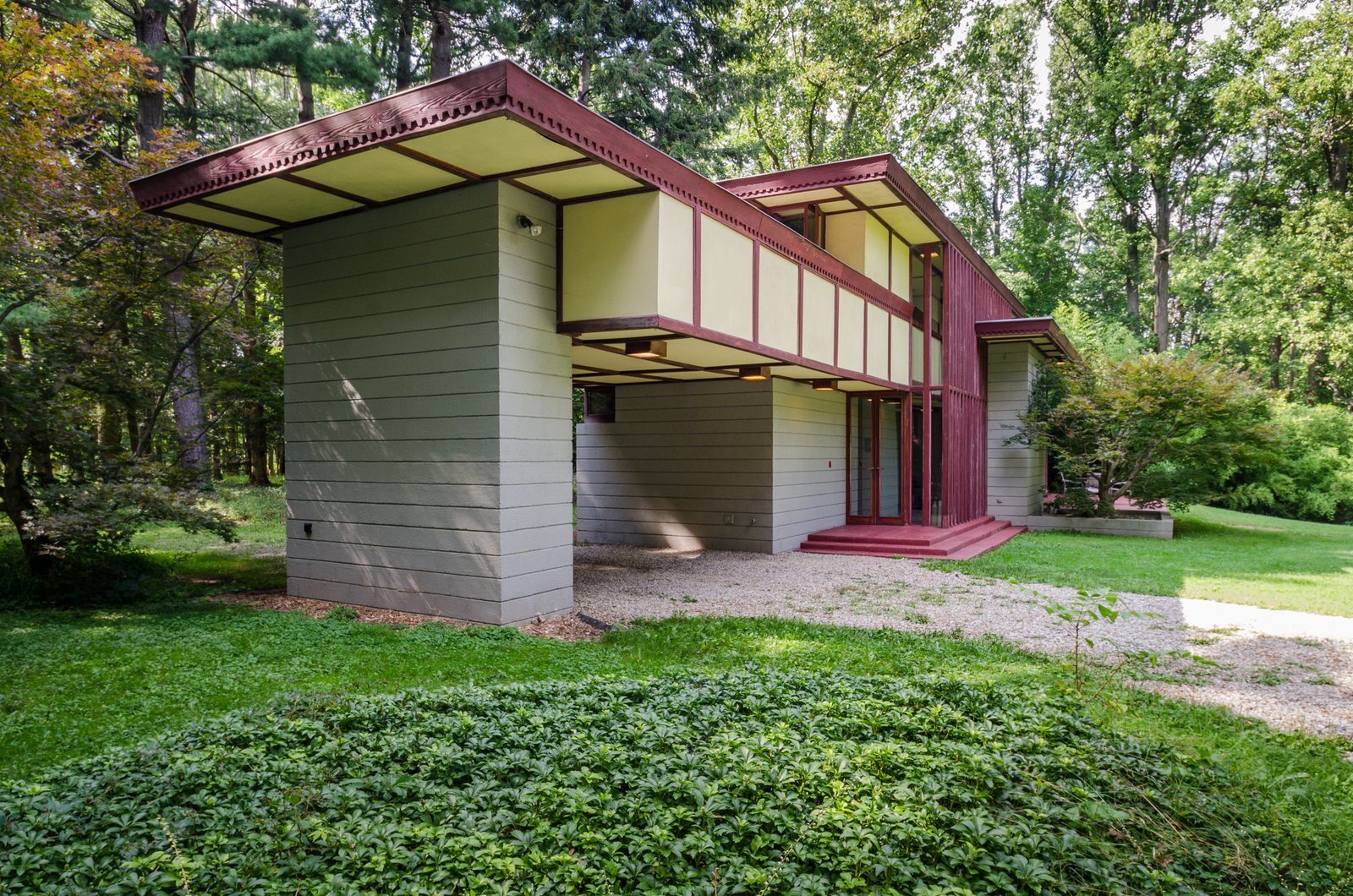 Designed by Frank Lloyd Wright and built in 1955, the Louis Penfield House is a 1,730-square-foot, residence in Lake County, Ohio, that has details like ribbon windows, “goutenjou” coffered ceilings, and a floating wooden staircase inspired by Japanese minimalism.