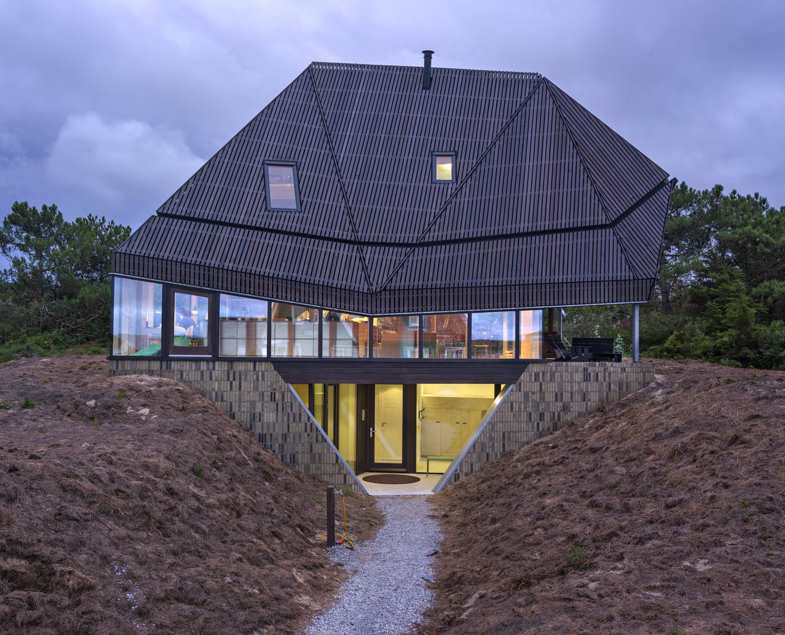 A concrete basement – where the bedrooms are located – is sunk beneath the dunes.