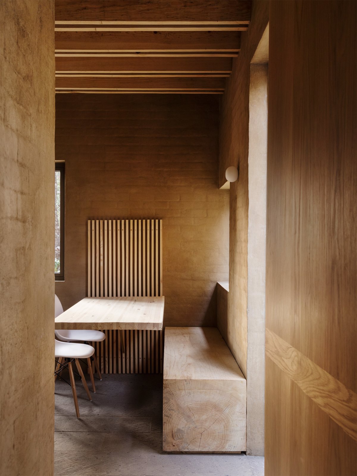 A dining area with a built-in bench and table.