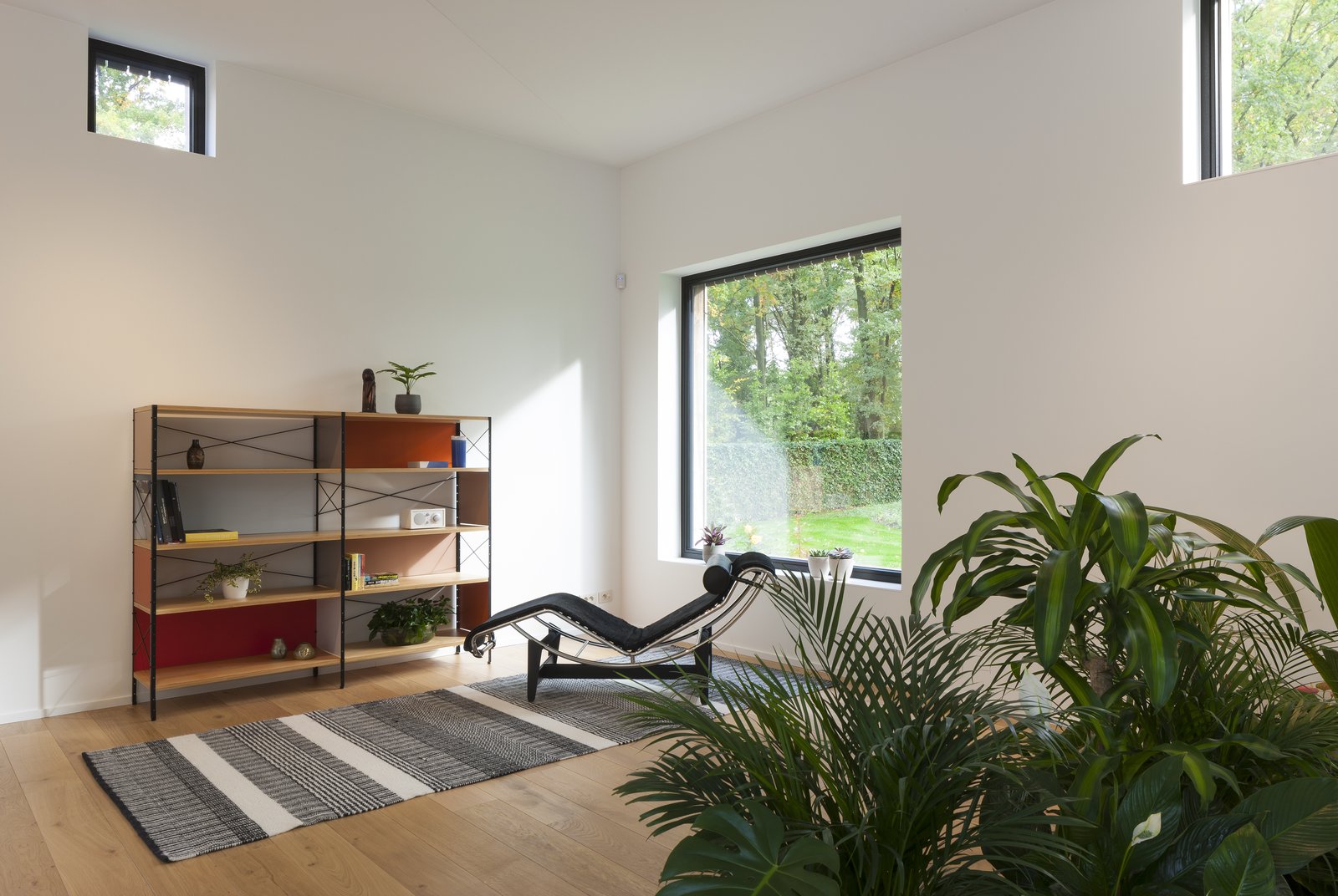 A black Arne Jacobsen Series 07 chair from Fritz Hansen, Eames storage shelf from Vitra.