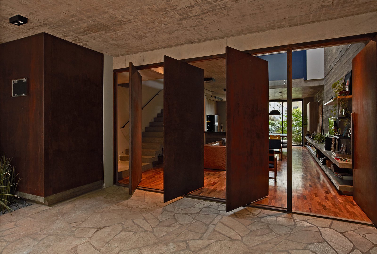 Four, pivoting Corten-steel doors help with cross ventilation.