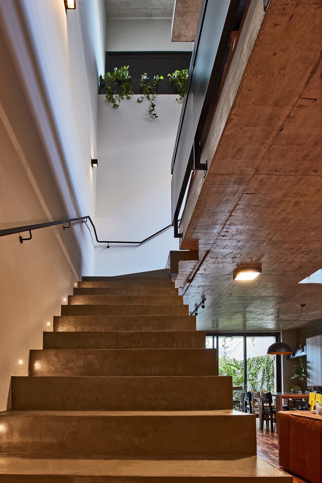 Concrete steps lead from the living room to the upper level.