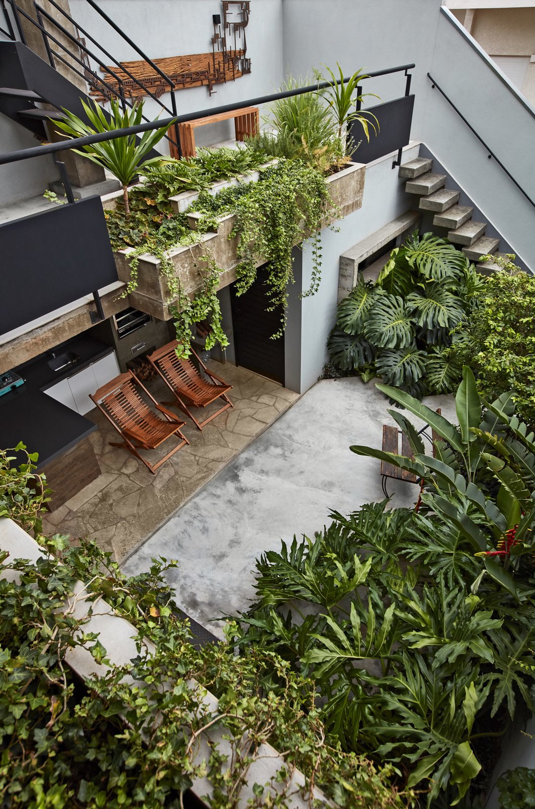 An outdoor kitchen in the lush, backyard garden.