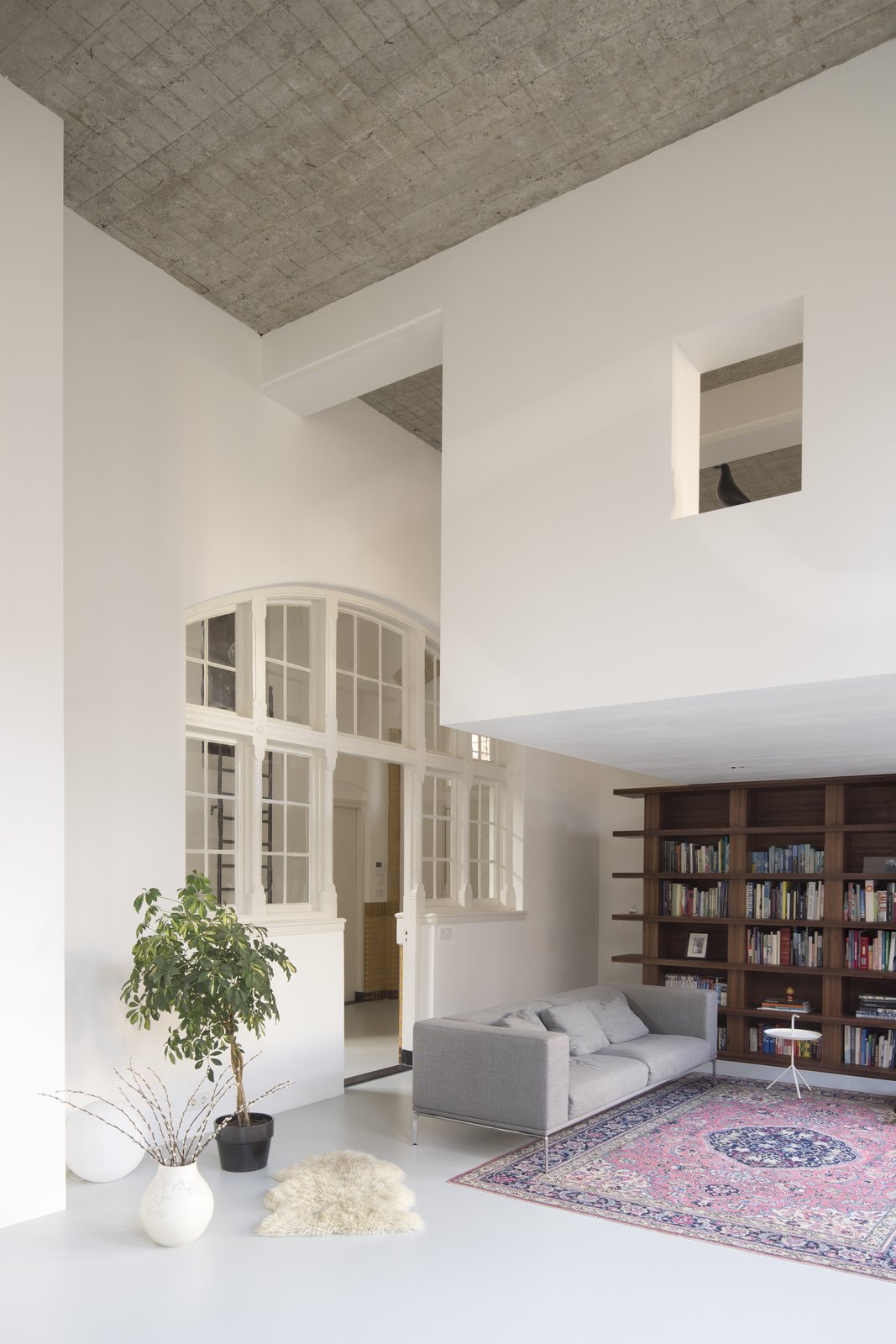 Behind the wooden bookshelf in the living lounge, is a hidden staircase that leads up to the workspace.