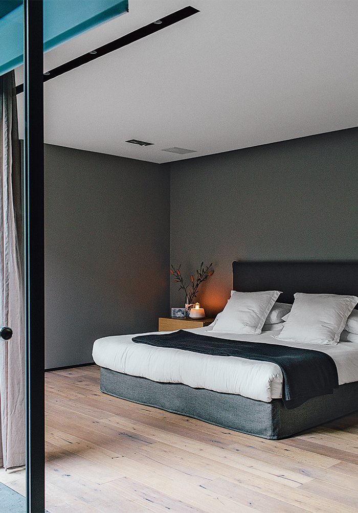 The master bedroom, painted in Whisper by Comex, sports a bed that Farca custom-designed as part of his EF Collection.