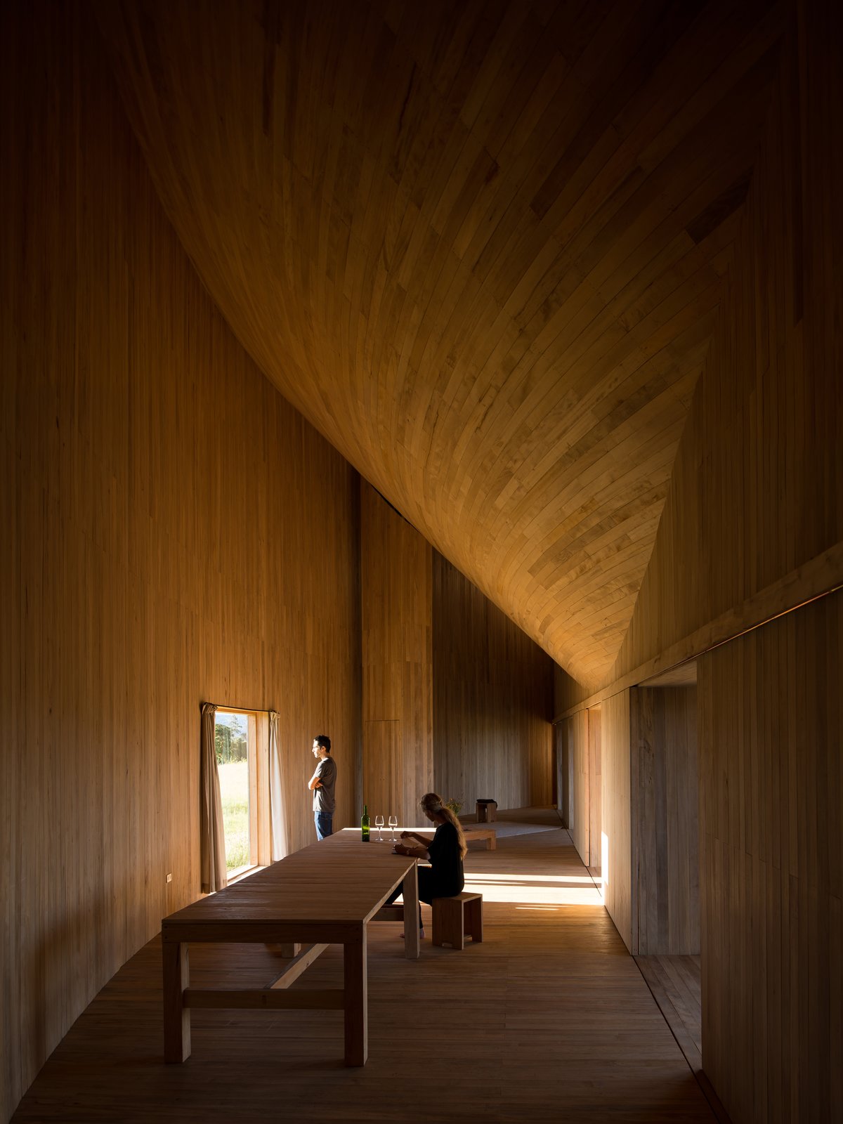 In the mid-section of the arc, is a simple living and dining space.