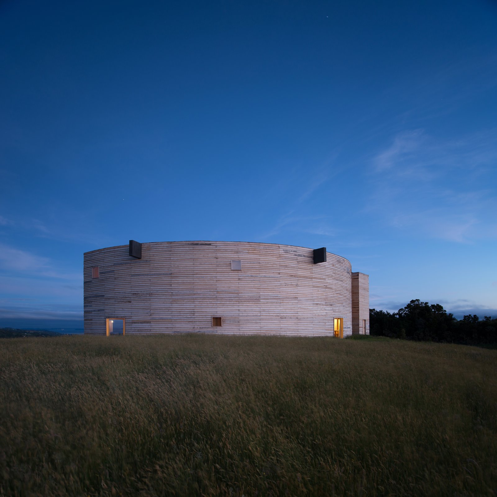 The 2,000-square-feet house has an enigmatic form that resembles a cylinder, cut in half along its diameter.