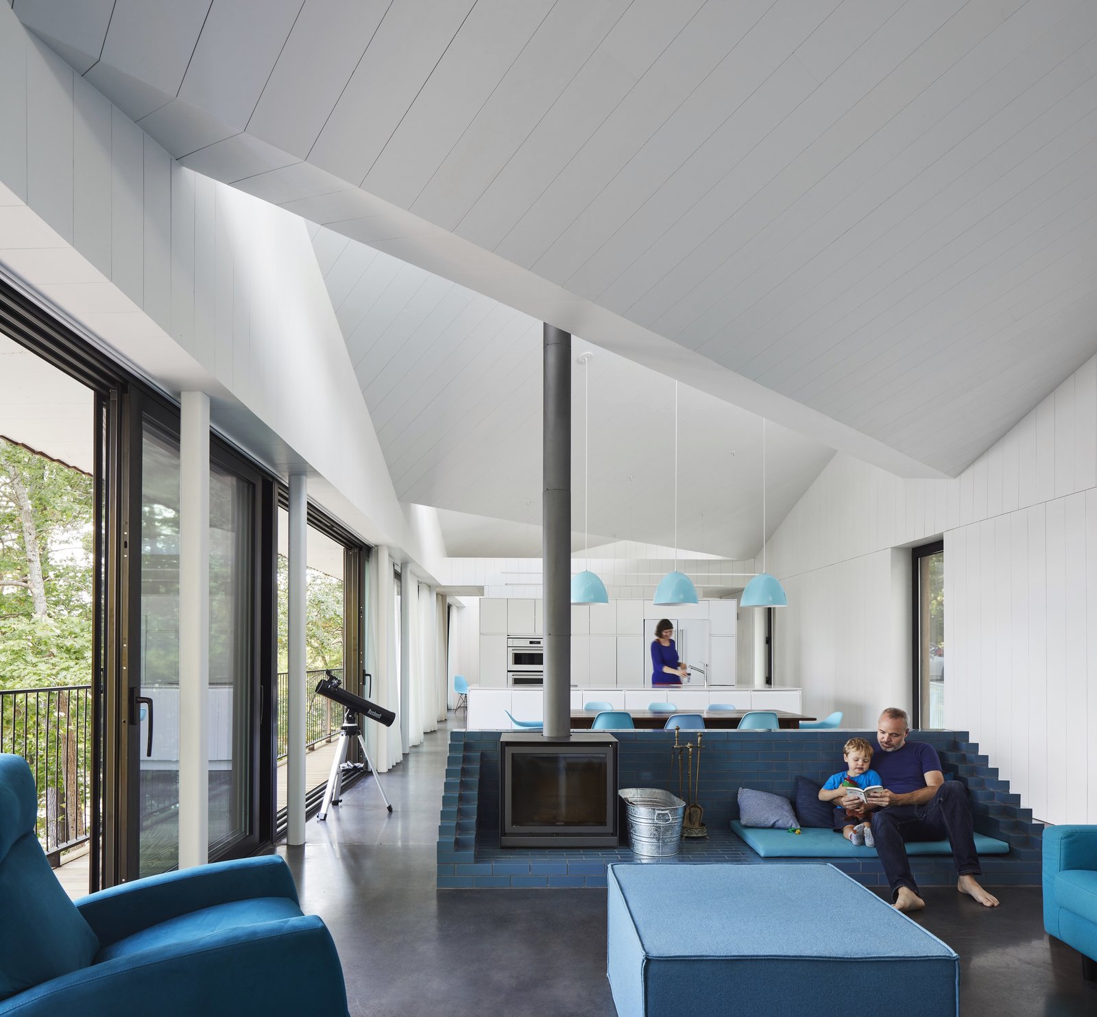 The wood stove is set within a blue, glazed brick socle.