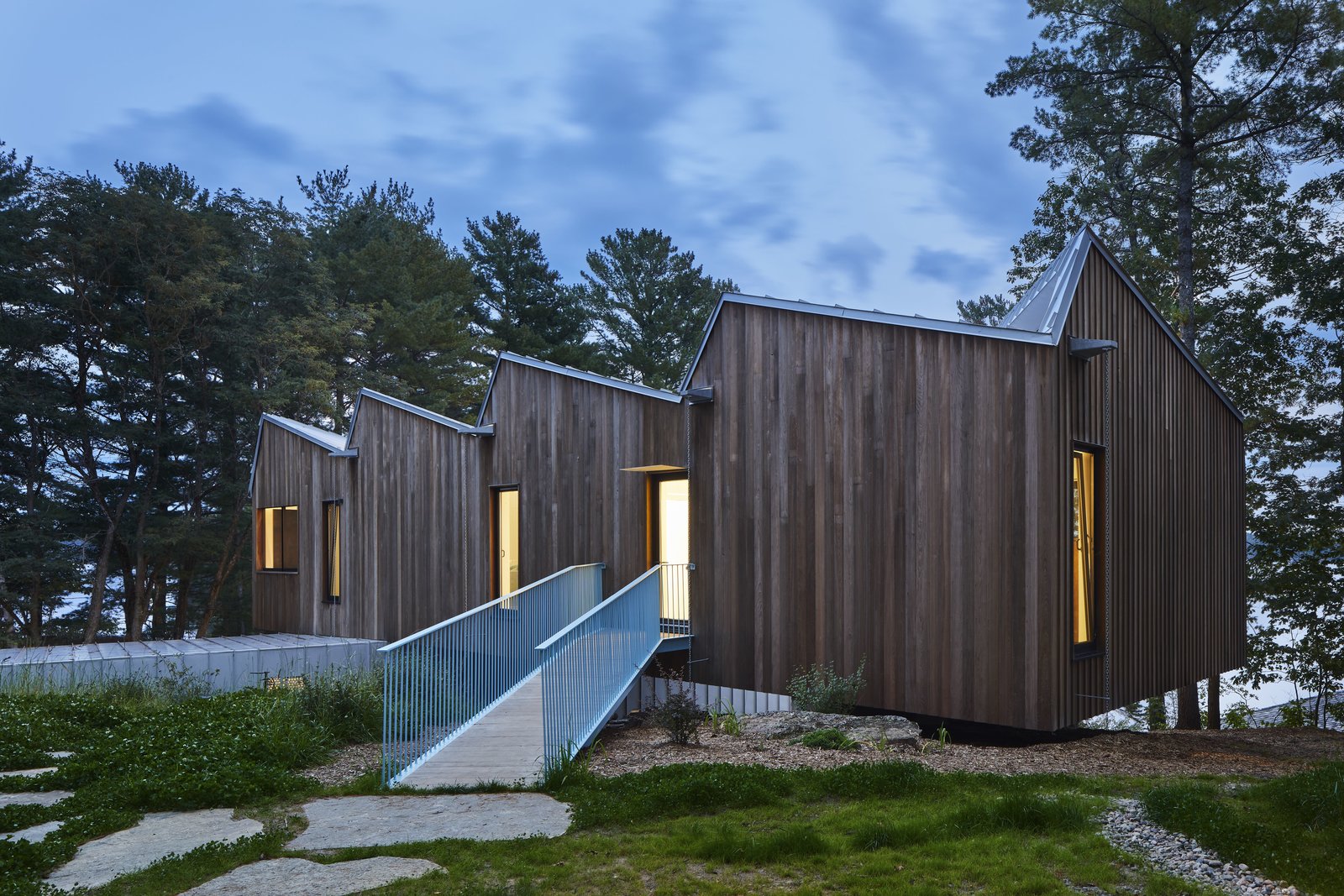A ramp leads to into the living areas located in the upper volume.