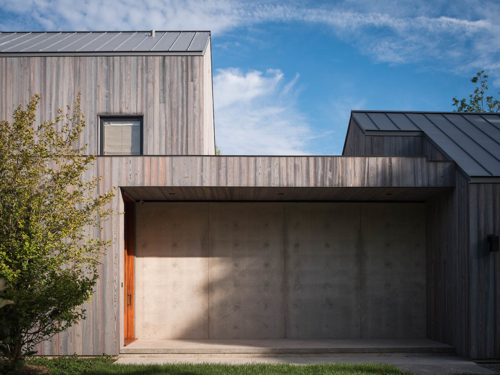 A house in Suffolk County with concrete foundational walls, charred siding siding and VMZinc zinc roof.