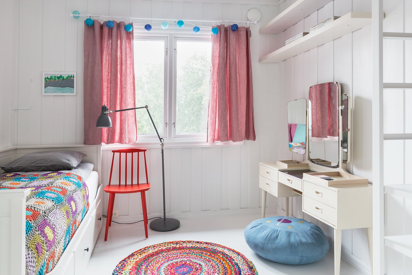Colorful bed spreads and rugs make this a cool bedroom for kids.