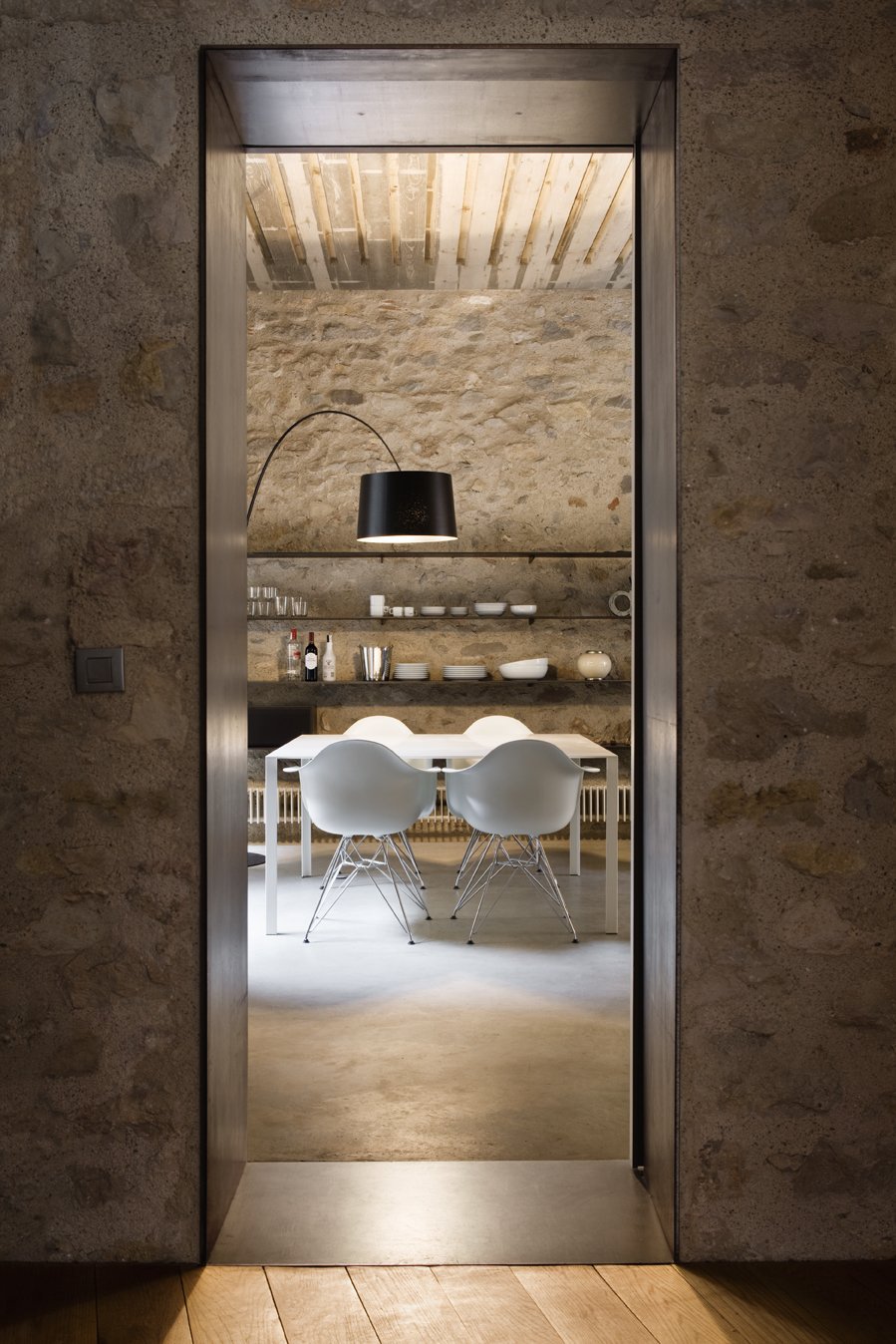 A narrow threshold evokes the warren-like feel of the original interiors.