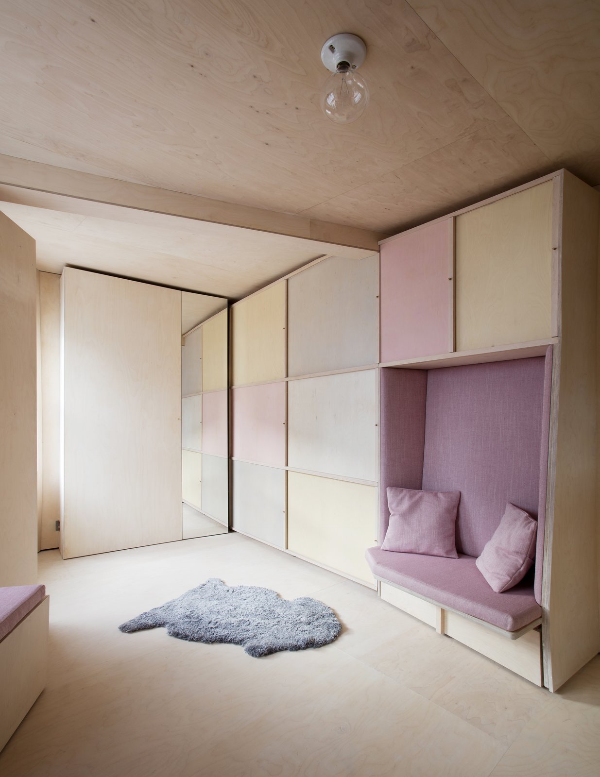 The fully-concealed workstation and storage next to a bench seat.