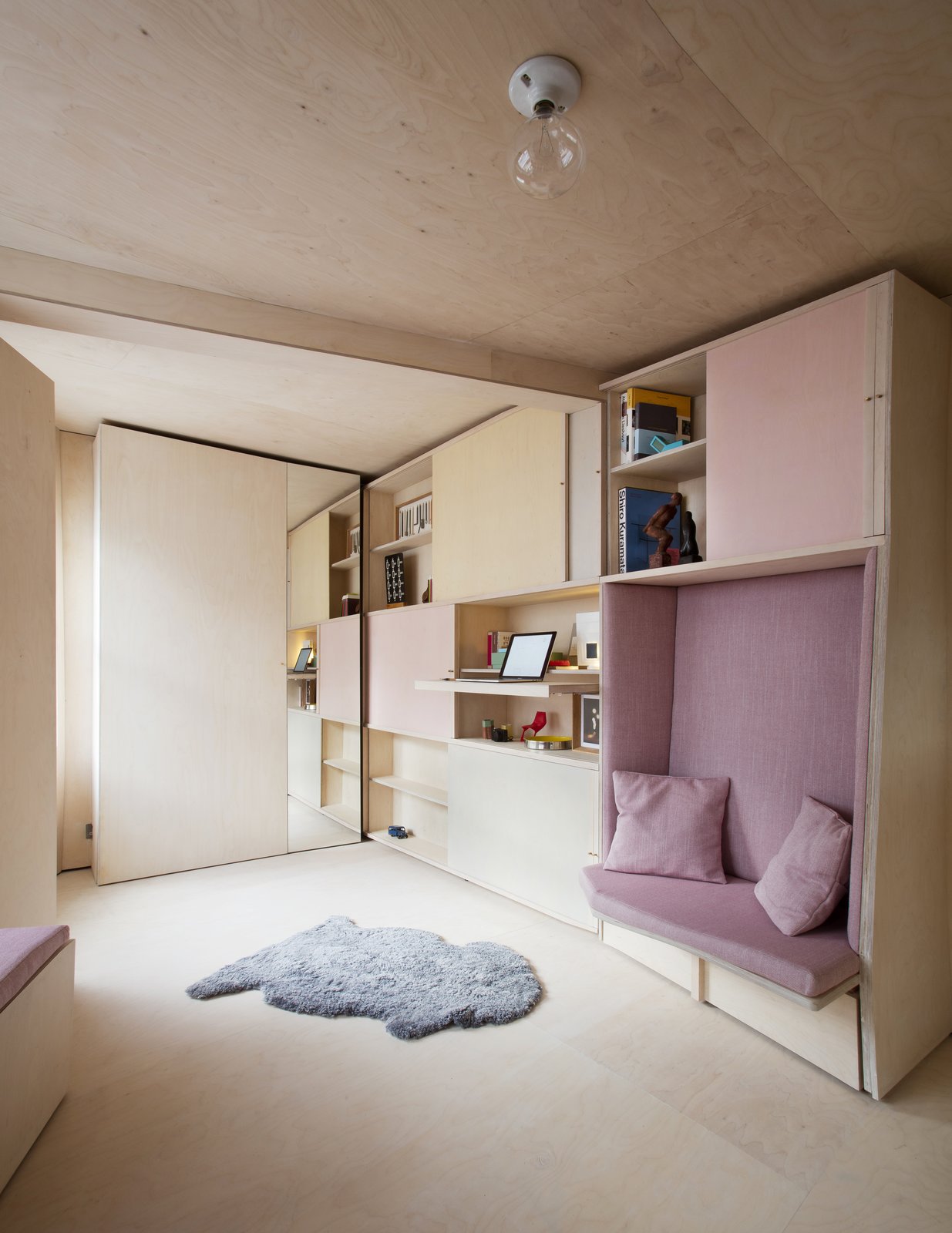 A pullout desk is hidden underneath one of the shelves.