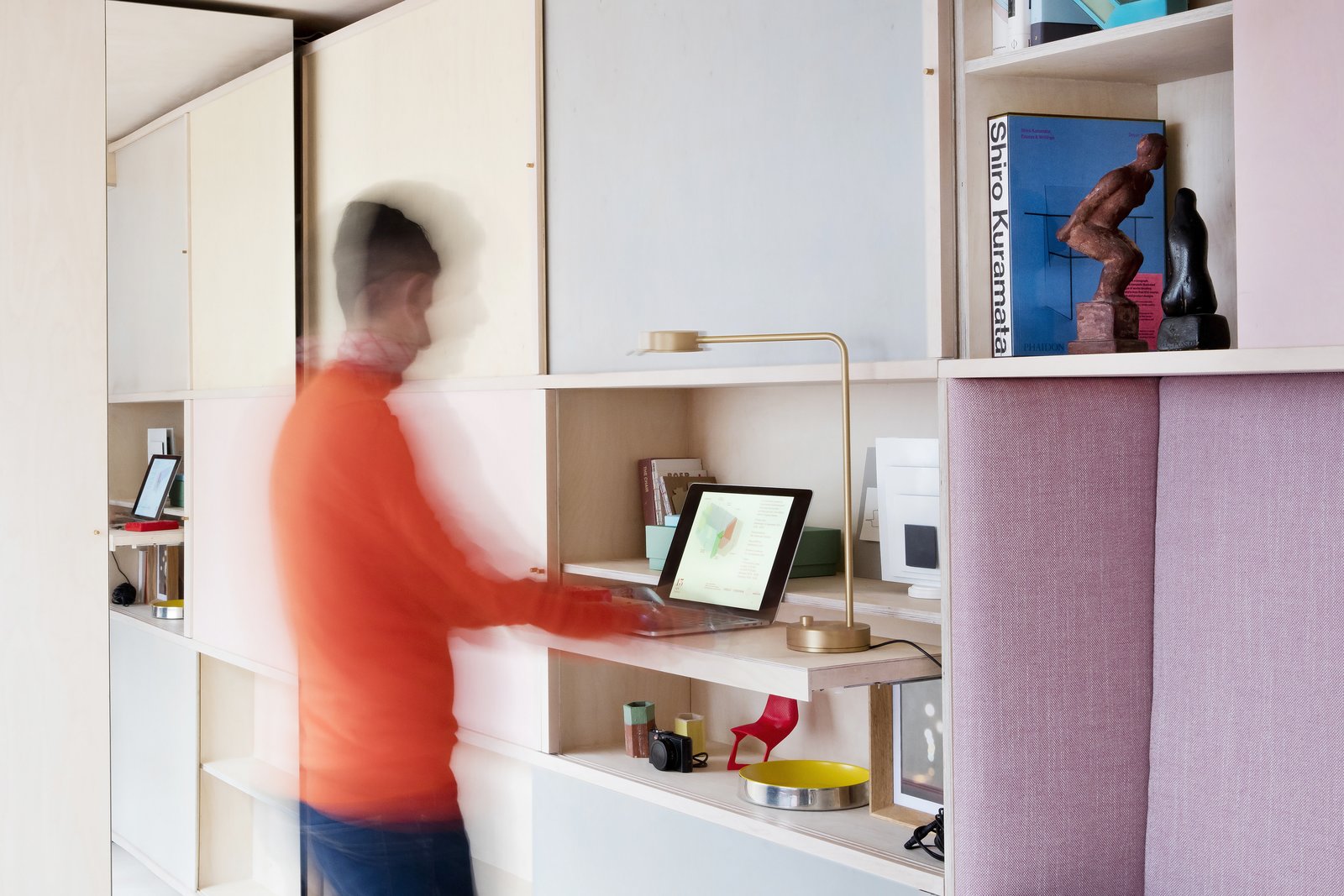 A standing work station with a pullout desk.