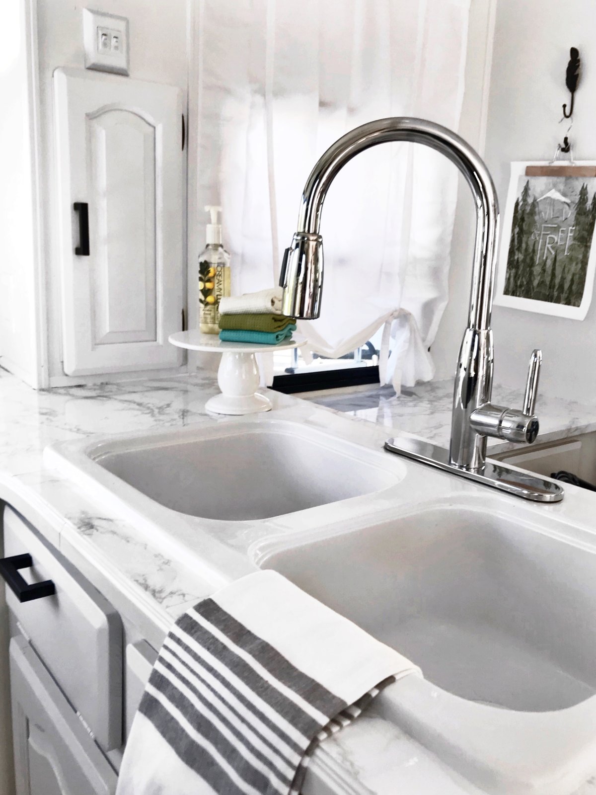 A gray, Hemnes/Rattviken sink cabinet from Ikea with two drawers.