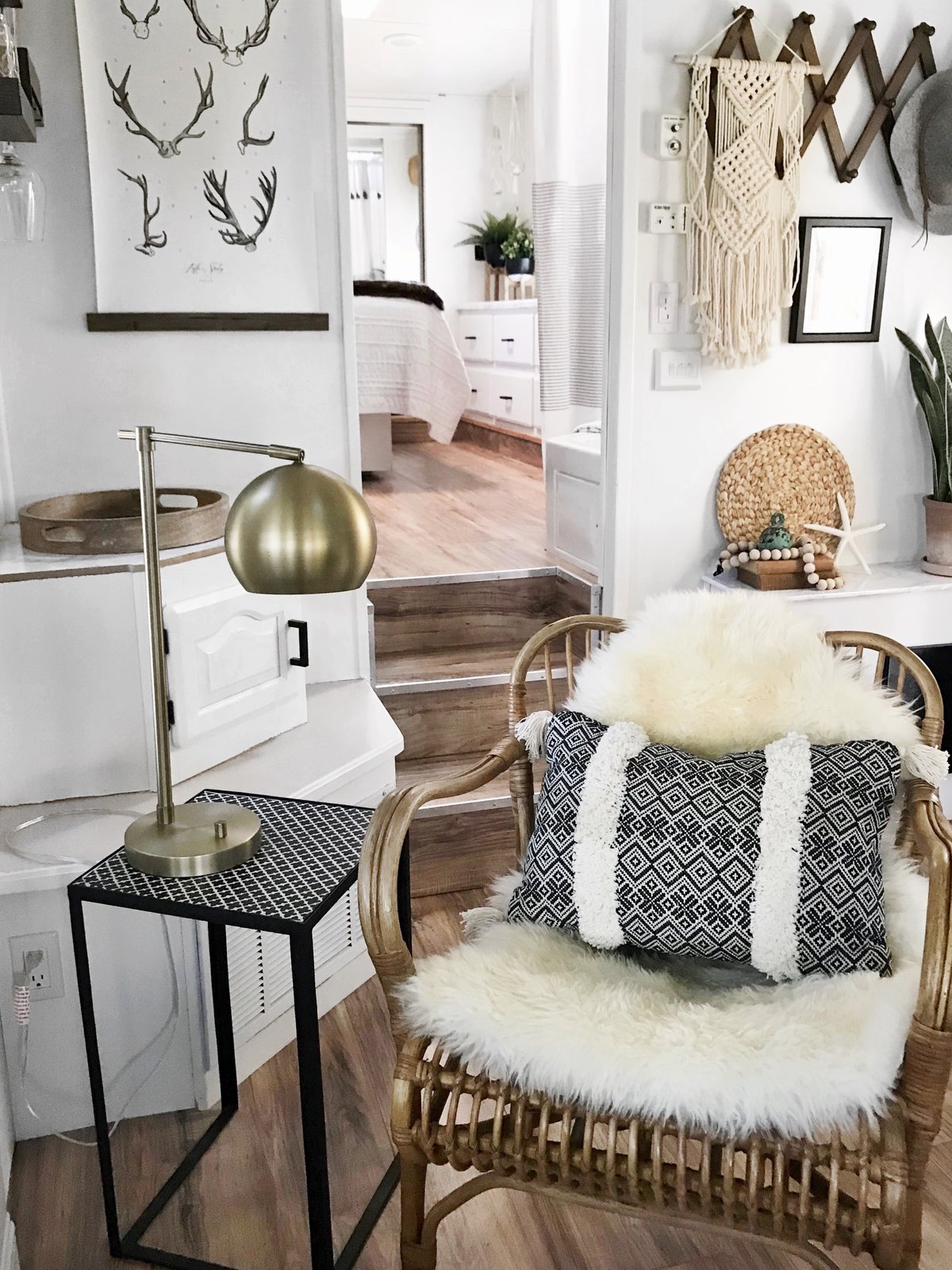 A sheepskin rug, a weave hanging on the wall, and vibrant fabrics add much personality to the small mobile home.