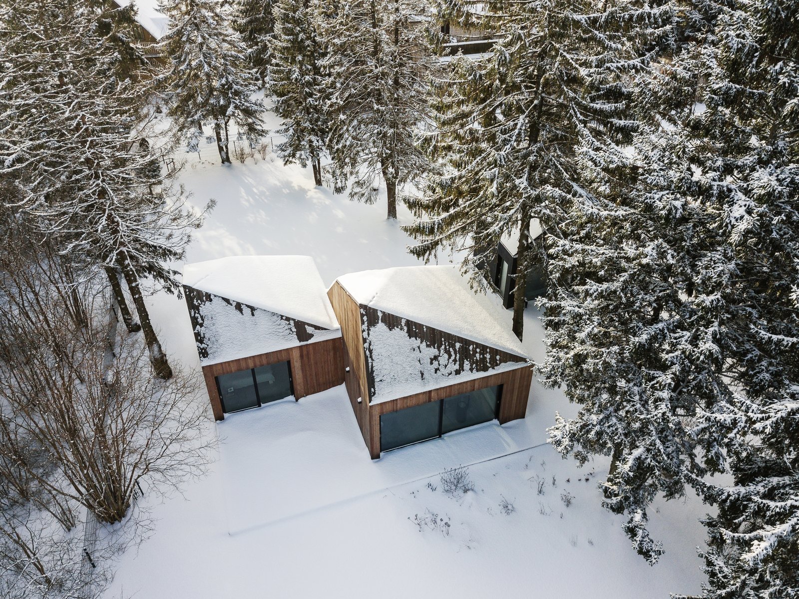 The pyramidal roofs of the cabins allow snow to slide down to the ground.